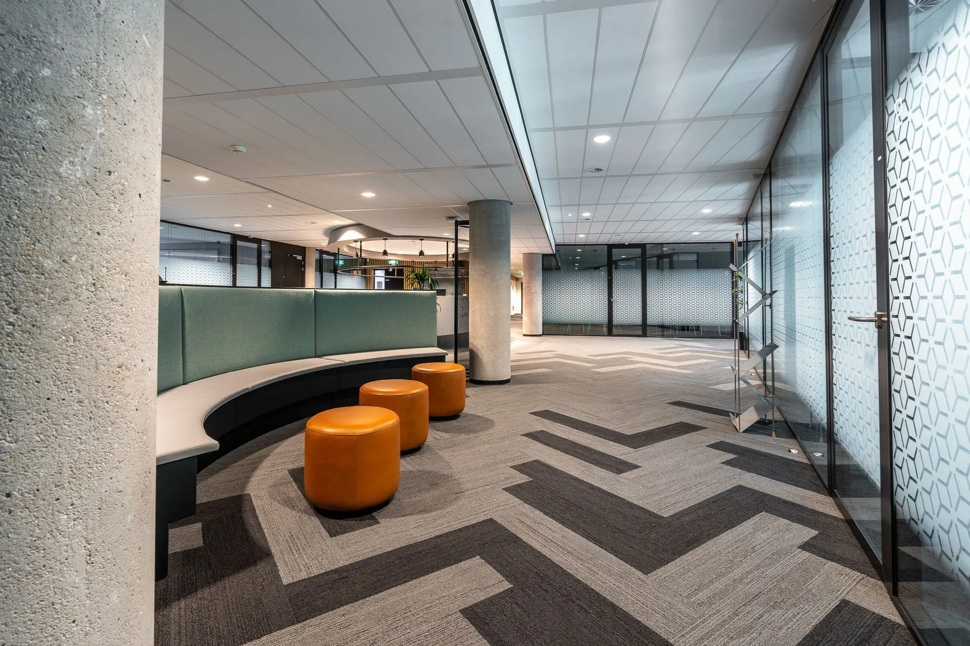 A clean carpet with a chevron pattern on the floor of a hallway